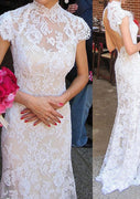 Vestido de novia de encaje con cola de barrido y manga casquillo con cuello alto de sirena