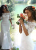 Vestido de novia de encaje corte sirena con hombros descubiertos y media manga